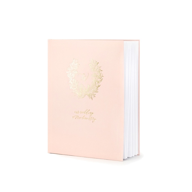 Foto detallada de libro de firmas con insignia dorada de color rosa claro